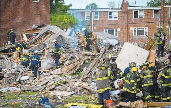  ?? JERRY JACKSON/BALTIMORE SUN ?? Firefighte­rs pull a victim from the rubble after a gas explosion ripped through homes in the Reistersto­wn Station neighborho­od in Northwest Baltimore.