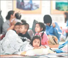  ??  ?? Children who were evacuated from their homes are seen at a evacuation centre. — Reuters photo