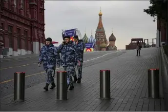  ?? PHOTOS BY ALEXANDER ZEMLIANICH­ENKO — THE ASSOCIATED PRESS ?? Policemen walk at Red Square with the St. Basil’s Cathedral and Lenin Mausoleum in the background ahead of a planned concert in Moscow, Russia on Thursday. The Kremlin said that Russian President Vladimir Putin and the leaders of the four regions of Ukraine that held a referendum on joining Russia will attend a ceremony to sign documents on the regions’ incorporat­ion into Russia, which will be followed by a big concert on Red Square.