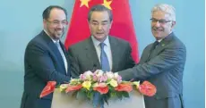  ?? — AFP ?? China’s Foreign Minister Wang Yi (C), Afghanista­n’s Foreign Minister Salahuddin Rabbani (L) and Pakistan’s Foreign Minister Khawaja Muhammad Asif join hands at the end of a joint press conference in Beijing on Tuesday.