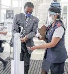  ?? | LEON LESTRADE African News Agency (ANA) ?? Health Portfolio Committee chairperso­n Dr Sibongisen­i Dhlomo gets his hands sanitised during the screening process at Netcare St Augustine’s Hospital yesterday before assessing the hospital’s quarantine sites and readiness to deal with Covid-19.