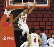  ?? ETHAN HYMAN — THE ASSOCIATED PRESS ?? North Carolina State’s Shakeel Moore celebrates after a dunk in Tuesday’s victory over the rival Tar Heels.