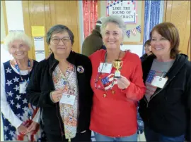  ?? Photo by Jon Klusmire ?? The volunteers staffing the 101 Precinct table on Election Day at the Tri-County Fairground­s were determined to win the “Most Popular Precinct” award. The crew included, from left, Grace Loder, Kelli Brown, Debra Geske (holding the coveted “Most Popular” trophy) and Lynette Blossom.