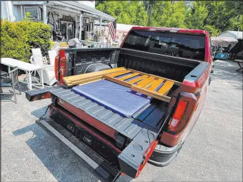  ?? Henry Payne The Detroit NEWS/TNS ?? On a trip to drop off furniture at a furniture resale shop, the 2023 GMC Sierra AT4X AEV Edition’s 4.6-foot short box was easy to load thanks to the Multipro tailgate.