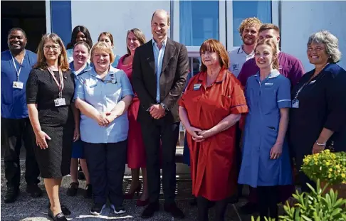  ?? ?? ROYAL VISIT: William, centre, meets staff at St Mary’s Community Hospital in Hugh Town, on the Isles of Scilly.