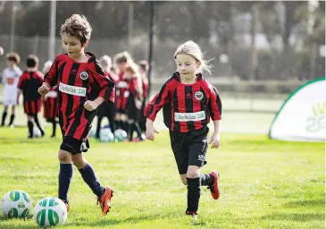  ??  ?? Hudson Zeldenryk and Elsa Box practice together before their MiniRoos game on Saturday.