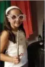  ?? SELAH HOVDA—ASSOCIATED PRESS ?? This August 2018photo provided by Selah Hovda shows a guest at her son’s Harry Potter-themed birthday party holding a homemade wand and Luna Lovegood glasses in Phoenix, Ariz. For the party Hovda made paper versions of Lovegood’s glasses and wands of wooden rods decorated with hot glue and paint.