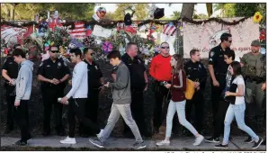  ?? AP/South Florida Sun-Sentinel/MIKE STOCKER ?? Officers greet Marjory Stoneman Douglas students as they arrive for class Wednesday.