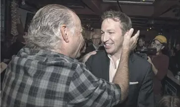  ?? Brian van der Brug Los Angeles Times ?? NICK MELVOIN, right, is greeted by a supporter May 16 in Venice at his election night gathering. Melvoin was elected in District 4, which stretches from the Westside to the west San Fernando Valley.