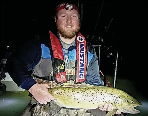  ?? (Special to The Commercial/University of Arkansas at Pine Bluff) ?? Derek Owens holds a brown trout sampled from the Greer’s Ferry Tailwater.