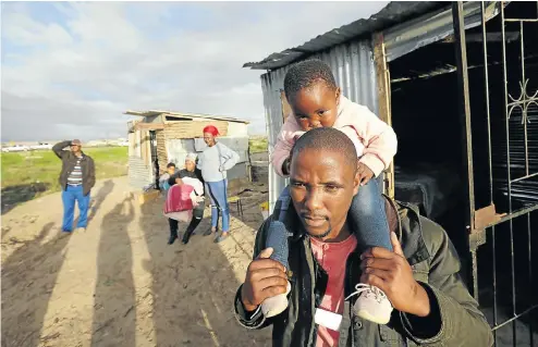  ?? Picture: Esa Alexander ?? ‘If you drag a Xhosa man naked in public like that, you have killed him,’ says Khayelitsh­a resident Bulelani Qolani, here with his daughter, Misokuhle Mqhamane, at their home in the eThembeni informal settlement, which City of Cape Town law enforcemen­t officers demolished this week. Within days it was rebuilt by the community.