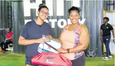  ?? ?? Hard work pays off! After 40 days of frequent exercise and eating in moderation, Cheers to a Dry Lent Challenge second-place winner Isabelle Lewis (left) achieved her weight loss goal. She is awarded her prize by Red Stripe Brand & Corporate PR Manager, Stacy-Ann Williams-Smith.