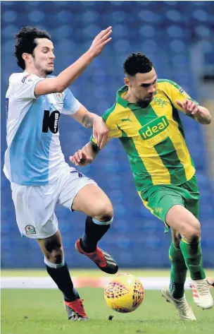  ?? Clint Hughes ?? Blackburn’s Lewis Travis, left, and West Brom’s Kieran Gibbs battle for the ball during the New Year’s Day clash