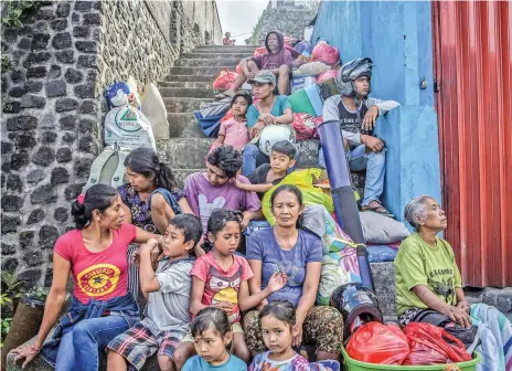  ?? Getty ?? People moved to safety yesterday from around Mount Agung, in Karangasem regency, wait for transport to temporary shelter