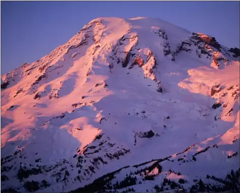  ?? CHRIS WEIDNER — COURTESY PHOTO ?? A winter view of Mt. Rainier at sunset. The Gibraltar Ledges route ascends near the right-hand skyline in this photo.