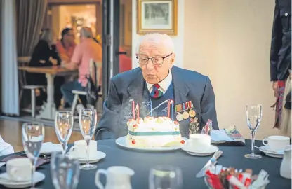  ?? Picture: Steve MacDougall. ?? “Well loved”: Mr Reid blowing out the candles on his birthday cake at his celebrator­y lunch.