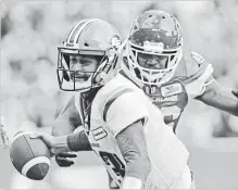  ?? MARK TAYLOR THE CANADIAN PRESS ?? Edmonton Eskimos quarterbac­k Mike Reilly is about to be sacked by Saskatchew­an Roughrider­s defensive lineman Willie Jefferson during CFL action in Regina on Monday. The Roughrider­s won, 19-12.