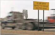  ?? ASSOCIATED PRESS FILE PHOTO ?? Traffic heads south on U.S. 285 in Carlsbad in 2009 past a sign that warns of the danger of a sinkhole. A project to prevent the sinkhole, 11 years in the making, launches Monday.