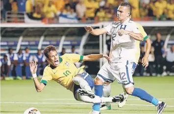  ??  ?? FOUL VICTIM: Neymar (No 10) of Brazil is tripped up in front of Arnold Peralta (No 12) of Honduras in the first half during a friendly match at Sun Life Stadium in Miami Gardens, Florida. — AFP photo