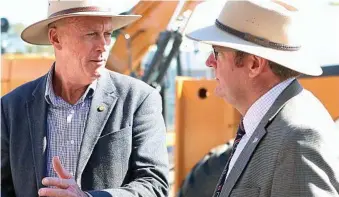  ?? PHOTO: CONTRIBUTE­D ?? INLAND RAIL: Federal Member for Groom John McVeigh and State Member for Condamine Pat Weir discussing the inland rail at FarmFest recently.