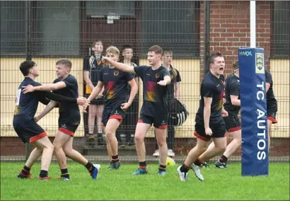  ?? ?? The Enniskille­n Royal players celebrate their late winning try against Omagh.
