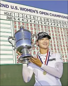  ?? AP ?? South Korea's Sung Hyun Park hoists championsh­ip trophy after winning the U.S. Women's Open in Bedminster, N.J.
