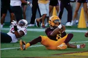  ?? ASSOCIATED PRESS ?? ARIZONA STATE QUARTERBAC­K JAYDEN DANIELS (5) scores a touchdown as he eludes Washington State safety Skyler Thomas (25) during the second half of Saturday’s game in Tempe.