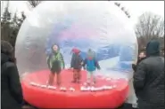  ?? KRISTI GARABRANDT — THE NEWS-HERALD ?? Zyad, 3. of Avon, Eli Kus, 5, and his younger brother Fin, 3, both of Litchfield, play in an inflatable snow globe during the Cleveland Metroparks Noon Year’s Eve at the Zoo.