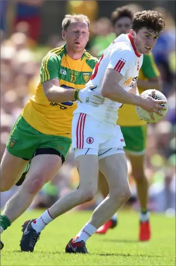  ??  ?? Rory Brennan of Tyrone is tackled by Anthony Thompson of Donegal during the Ulster final.