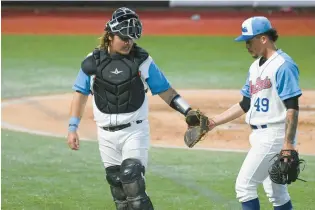  ?? BRIAN KRISTA/STAFF ?? Catcher Creed Willems, left, and pitcher Moisés Chace celebrate after a strikeout during the High-A Aberdeen IronBirds’ season opener earlier this month.