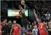  ?? TONY DEJAK — THE ASSOCIATED PRESS ?? Cleveland’s LeBron James (23) hits the game-winning shot as Toronto’s OG Anunoby (3) defends and CJ Miles (0) watches Saturday in Cleveland.