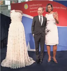  ?? MARK WILSON, GETTY IMAGES ?? Michelle Obama and designer Jason Wu help to enshrine the gown she wore to the inaugural balls in a Smithsonia­n exhibit.