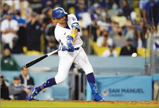  ??  ?? Los Angeles Dodgers’ AJ Pollock drives in a run with a single during the eighth inning against the Atlanta Braves in a baseball game, on Sept 1, in Los Angeles. (AP)