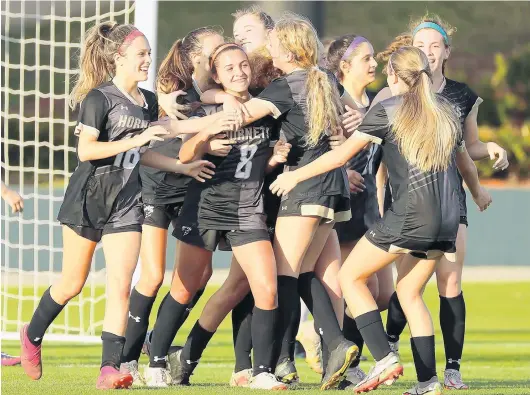  ?? ?? Bishop Moore players celebrate after scoring a goal during the Class 4A state championsh­ip game against American Heritage at Spec Martin Stadium in DeLand on Feb. 23. STEPHEN M. DOWELL/ORLANDO SENTINEL