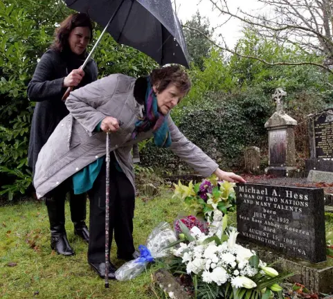  ?? Photo: Mark Stedman ?? SPLIT: Philomena Lee and daughter Jane Libberton at the grave of Philomena’s son Michael Hess in the grounds of Sean Ross Abbey, Roscrea. He was forcibly adopted in the mid-1950s after his mother gave birth to him at the home.