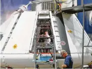  ?? Steve Gonzales / Houston Chronicle ?? Johnson Space Center workers prepare the Orion test module to be powered up for the first time.