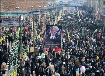  ?? PICTURE: AP ?? Iranians carry a banner showing a caricature of US president Donald Trump during a rally yesterday commemorat­ing the anniversar­y of the 1979 Islamic revolution, which toppled the late pro-US shah.