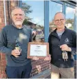  ?? PHOTOS: SRL ?? Stafford Riverway Link chairman Paul Bryan presents the lifetime membership certificat­e to David Bott, director of Titanic Brewery.