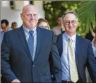  ?? LANNIS WATERS / THE PALM BEACH POST ?? Former Boynton Beach police officer Michael Brown
(left) leaves federal court Tuesday with his attorney, Bruce Reinhart, after being sentenced to three years probation, 150 hours of community service and 180 days of electronic monitoring.