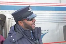  ??  ?? Amtrak conductor Maurice Threets talks to passengers boarding the Winter Park Express. The trip takes about two hours.