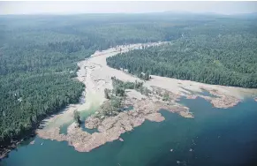  ?? — THE CANADIAN PRESS FILES ?? Contents from a tailings pond are carried down the Hazeltine Creek into Quesnel Lake in August 2014. That spill has led to regulatory changes now being introduced.
