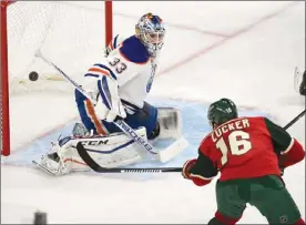  ?? The Associated Press ?? Minnesota Wild forward Jason Zucker scores past Edmonton Oilers goalie Cam Talbot during an NHL game on Friday in St. Paul, Minn. The Wild won 3-2 in a shootout.