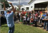  ?? RICHARD PAYERCHIN - THE MORNING JOURNAL ?? Homing pigeons are almost ready to take flight as Todd Clement, left, gestures and explains the release of the birds at the Lorain County Fair on Aug. 24.