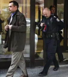  ?? ANDREW FRANCIS WALLACE/TORONTO STAR ?? Const. Michael Adams, left, and Sgt. Stuart Blower leave inquest into the death of Junior Manon. The officers were arresting Manon when he died.