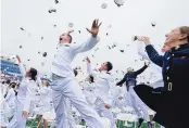  ?? MANUEL BALCE CENETA/ASSOCIATED PRESS ?? U.S. Naval Academy graduates celebrate and throw their covers at the end of the academy’s graduation and commission ceremony in Annapolis, Md., on Friday.