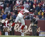  ?? ALEX BRANDON - THE ASSOCIATED PRESS ?? New York Giants running back Saquon Barkley catches a touchdown pass from quarterbac­k Daniel Jones during the first half of a game against the Washington Redskins, Sunday, Dec. 22, 2019, in Landover, Md.