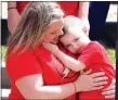  ?? Photo by Mike Eckels ?? An overwhelme­d Remington Anderson (right) found comfort in his mother Tina’s arms.