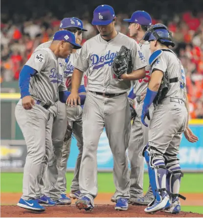  ?? | TOM PENNINGTON/ GETTY IMAGES ?? The Dodgers’ Yu Darvish exits the game early Friday night after the Astros roughed him up in the second.