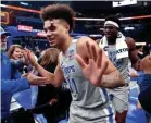  ?? JOE RONDONE/THE COMMERCIAL APPEAL ?? Memphis Tigers guard Lester Quinones and center Malcolm Dandridge high-five fans after their 77-73 win over the East Carolina Pirates at the Fedexforum on Feb. 19.