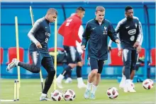  ?? DAVID VINCENT THE ASSOCIATED PRESS ?? France's Kylian Mbappe, left, and Antoine Griezmann dribble the ball during a training session in Glebovets, Russia, on Wednesday.
